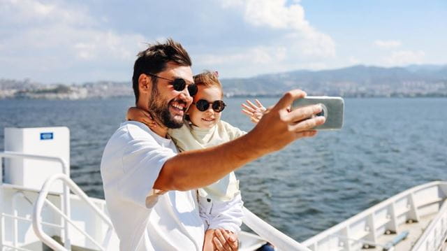 Father and son take selfie on cruise ship